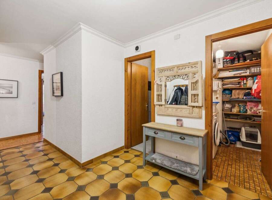 Step into this inviting entryway, showcasing a stylish console table and a decorative mirror.