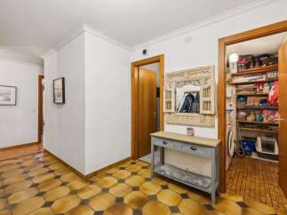 Step into this inviting entryway, showcasing a stylish console table and a decorative mirror.