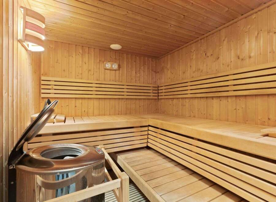 Step into relaxation with this stunning sauna! Featuring beautiful wooden benches and walls, this space offers the perfect escape for unwinding.