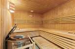 Step into relaxation with this stunning sauna! Featuring beautiful wooden benches and walls, this space offers the perfect escape for unwinding.