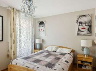 This cozy bedroom features a comfortable bed with a stylish quilt, perfect for a relaxing retreat.