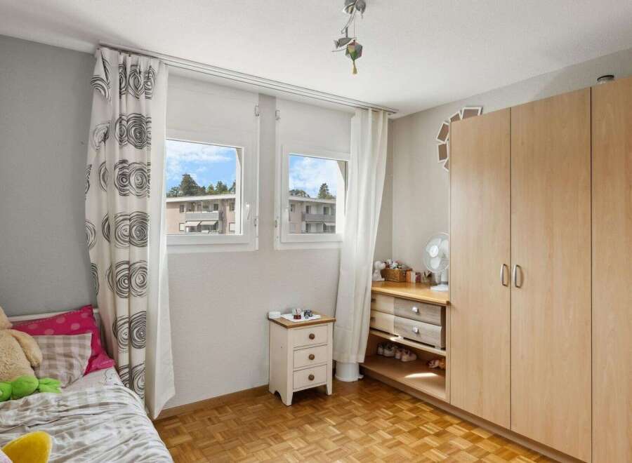This charming bedroom features a cozy bed, perfect for relaxation.