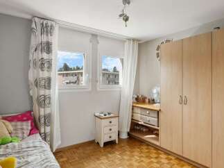 This charming bedroom features a cozy bed, perfect for relaxation.