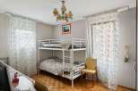 Discover this charming bedroom featuring a cozy bunk bed, perfect for accommodating guests or family members.