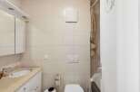 This bathroom features a clean and modern design with neutral-colored tiles.