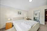 This inviting bedroom features a comfortable bed with a cozy duvet, perfect for a relaxing stay.