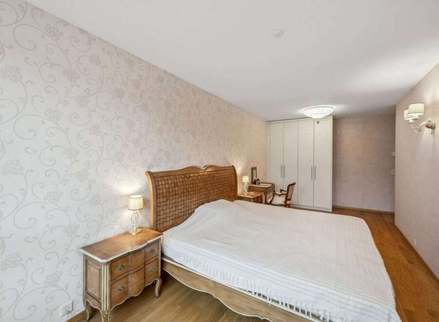This elegant bedroom features a stunning woven headboard and a cozy bed, perfect for relaxation.