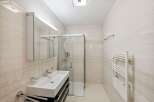 Step into this modern bathroom, featuring a sleek glass shower enclosure and a stylish vanity.