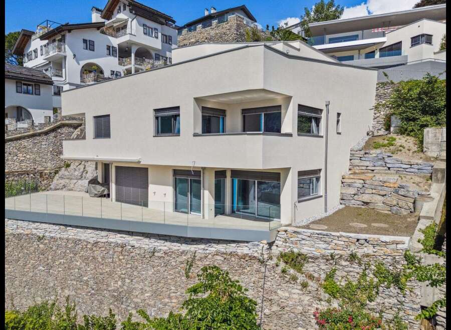 Discover modern luxury in this stunning property! This home boasts sleek architecture, featuring expansive windows and a stylish balcony.