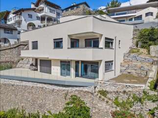 Discover modern luxury in this stunning property! This home boasts sleek architecture, featuring expansive windows and a stylish balcony.