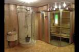 Step into luxury with this spa-like bathroom featuring a modern shower and a relaxing sauna.