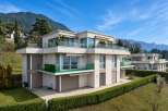 Discover modern luxury in this stunning property, featuring sleek architecture and expansive glass balconies.