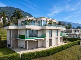 Discover modern luxury in this stunning property, featuring sleek architecture and expansive glass balconies.