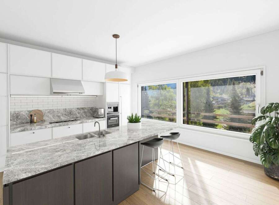 This stunning kitchen boasts a modern design with sleek white cabinetry and a beautiful marble countertop.