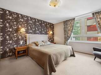 This inviting bedroom boasts a cozy ambiance, perfect for relaxation.