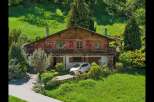 Nestled in a serene, green landscape, this charming wooden house offers a perfect blend of rustic charm and modern comfort.