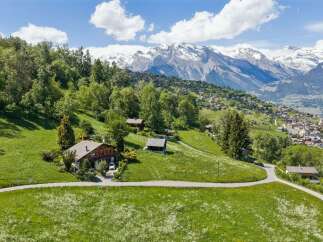 Nestled in a picturesque mountain landscape, this charming property offers a serene escape.