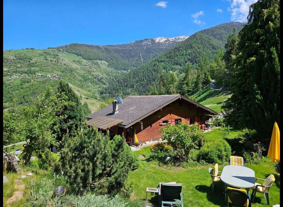 Escape to your dream home nestled in the heart of nature! This stunning property boasts a charming wooden house with a picturesque view of the mountains.