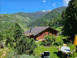Escape to your dream home nestled in the heart of nature! This stunning property boasts a charming wooden house with a picturesque view of the mountains.