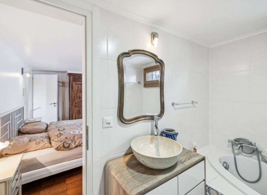 Discover this charming property featuring a well-appointed bathroom with a stylish sink and mirror.