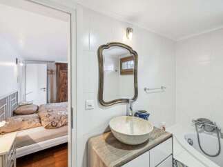 Discover this charming property featuring a well-appointed bathroom with a stylish sink and mirror.