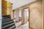 Step into luxury with this stunning property featuring a modern staircase and elegant hallway.