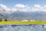 Experience ultimate relaxation with this stunning hot tub, offering breathtaking panoramic views of majestic mountains.