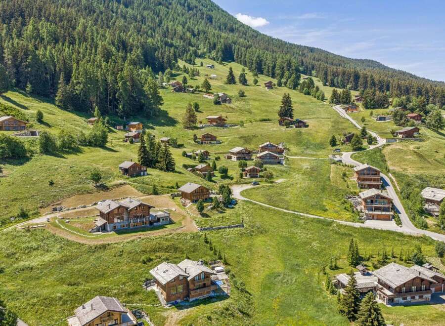 Nestled on a lush green mountainside, this charming village features traditional wooden chalets with stunning panoramic views.