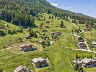 Nestled on a lush green mountainside, this charming village features traditional wooden chalets with stunning panoramic views.
