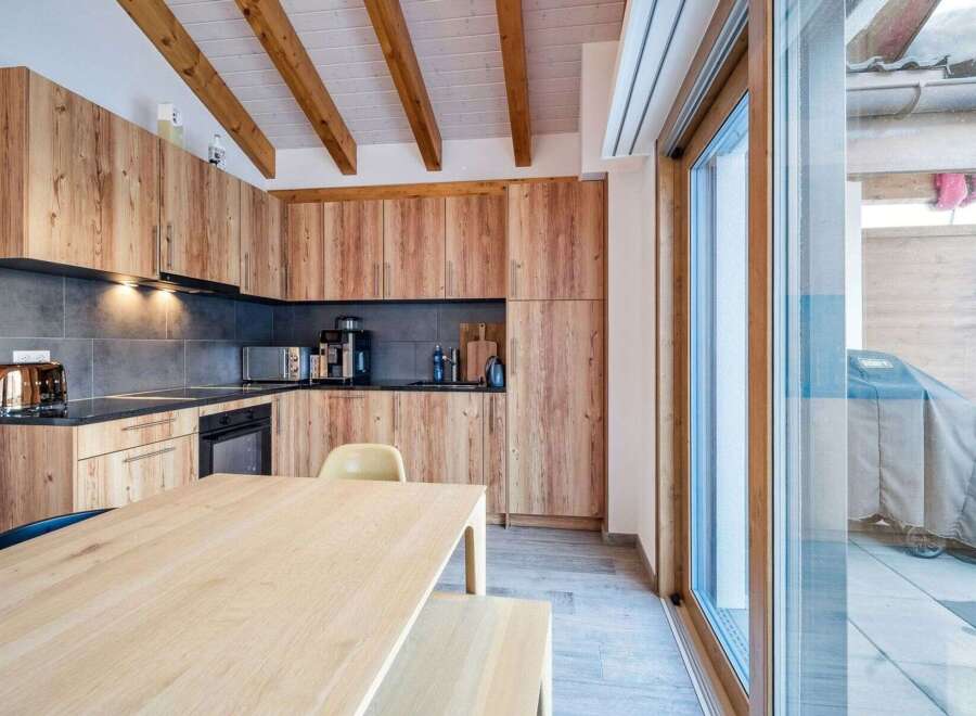 This stunning kitchen boasts custom wooden cabinetry and a sleek countertop, perfect for culinary enthusiasts.