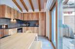 This stunning kitchen boasts custom wooden cabinetry and a sleek countertop, perfect for culinary enthusiasts.