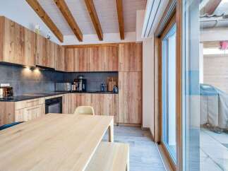 This stunning kitchen boasts custom wooden cabinetry and a sleek countertop, perfect for culinary enthusiasts.