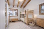 This charming bedroom features a cozy bunk bed, perfect for a family or guests.