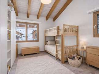 This charming bedroom features a cozy bunk bed, perfect for a family or guests.