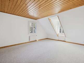 Discover the charm of this bright and airy room, featuring a stunning wooden ceiling that adds warmth and character.