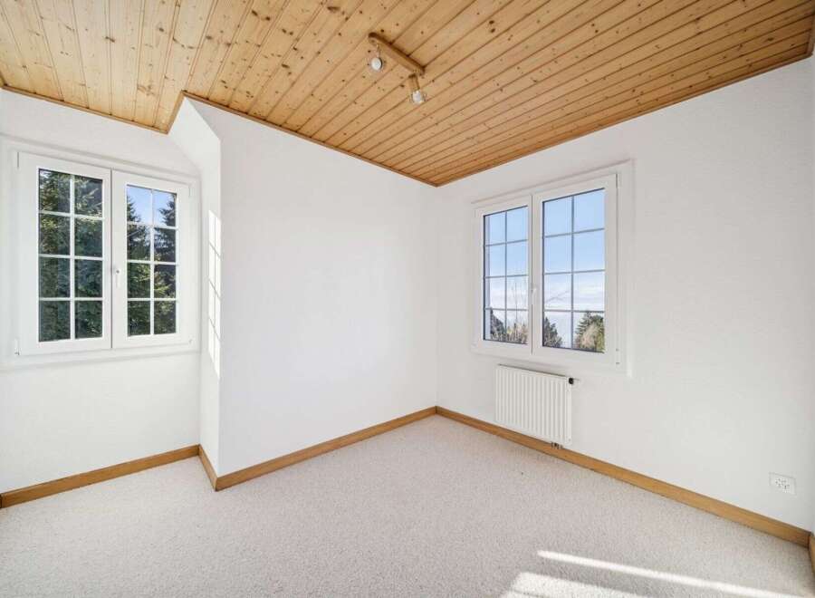Discover the charm of this bright and airy room, featuring a beautiful wooden ceiling that adds warmth and character.