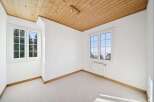 Discover the charm of this bright and airy room, featuring a beautiful wooden ceiling that adds warmth and character.