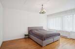 This inviting bedroom features a comfortable bed with a stylish headboard, perfect for relaxation.