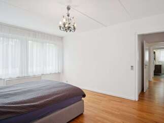 This bright and airy bedroom offers a serene retreat.