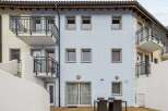 Discover this charming property featuring a light blue facade, complemented by balconies and stylish windows.