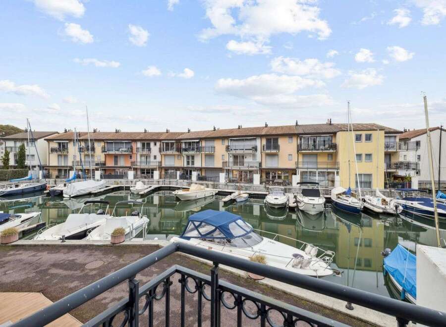 Discover waterfront living at its finest! This stunning property boasts a prime location with direct access to a marina, perfect for boating enthusiasts.