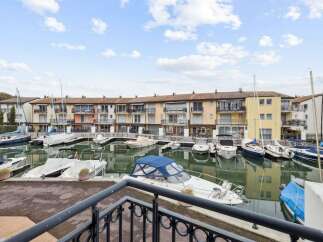 Discover waterfront living at its finest! This stunning property boasts a prime location with direct access to a marina, perfect for boating enthusiasts.