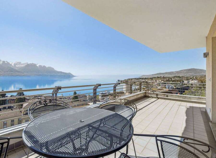 Enjoy breathtaking views from this stunning property! This home features a spacious balcony with a stylish metal table and chairs, perfect for relaxing and entertaining.