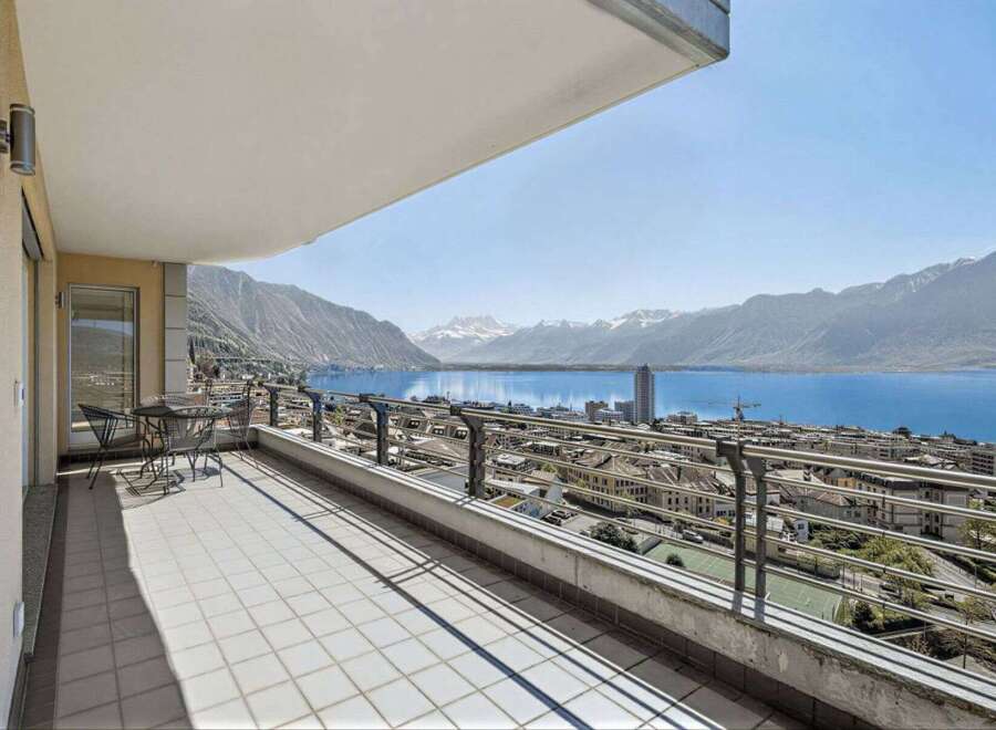 Enjoy breathtaking views from this stunning balcony overlooking the serene lake and majestic mountains.