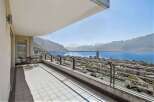 Enjoy breathtaking views from this stunning balcony overlooking the serene lake and majestic mountains.