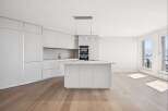 Experience modern luxury in this stunning kitchen! Featuring sleek, white cabinetry, a spacious island, and high-end appliances, this space is perfect for both cooking and entertaining.