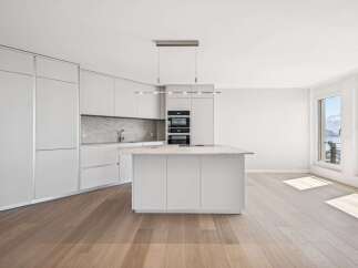Experience modern luxury in this stunning kitchen! Featuring sleek, white cabinetry, a spacious island, and high-end appliances, this space is perfect for both cooking and entertaining.