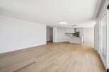 This stunning property boasts a modern, open-plan living space with beautiful hardwood floors.