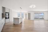 Experience modern luxury in this stunning property featuring a sleek, contemporary kitchen with high-end appliances and a stylish island.