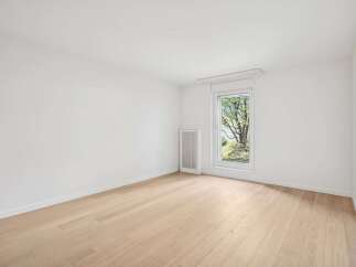 Discover the charm of this bright and airy room, featuring pristine white walls and elegant hardwood floors.